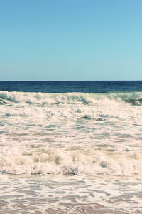 Scenic view of beach against blue sky