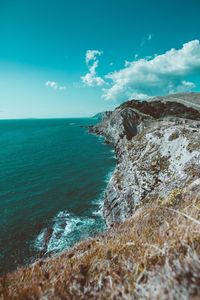 Scenic view of sea against cloudy sky