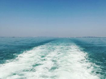 Scenic view of sea against clear blue sky