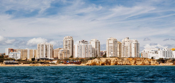 City by water against sky