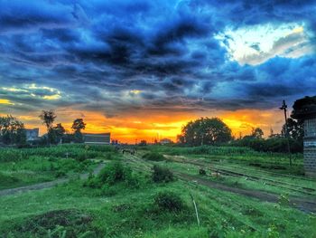 Scenic view of field against cloudy sky