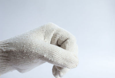 Close-up of person hand against white background