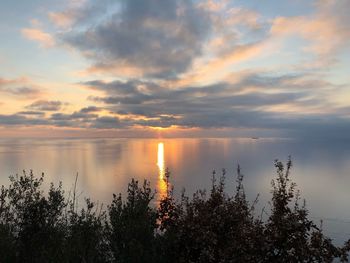 Scenic view of lake against sky during sunset