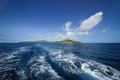 Scenic view of sea against blue sky