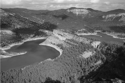 High angle view of land and mountains against sky