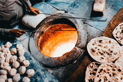 High angle view of man preparing nan bread 