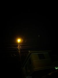 Low angle view of illuminated street light at night