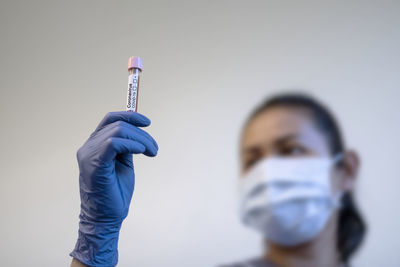 Scientist holding medical sample in test tube