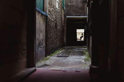 Empty alley amidst buildings in city