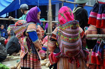 Rear view of people at market