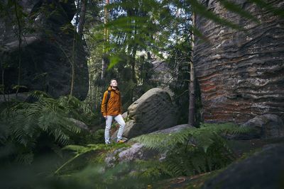 Man standing amidst forest