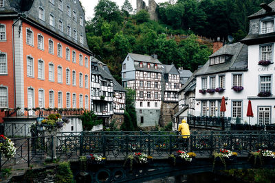 Buildings by river in city