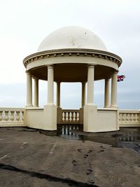 Gazebo in city against sky