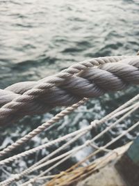 Close-up of rope on ship against sea