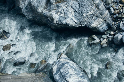 High angle view of rocks in sea