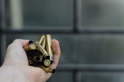 Close-up of hand holding bullet cartridges