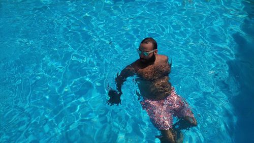 High angle view of man swimming in pool