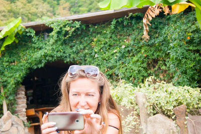Portrait of young woman using smart phone outdoors