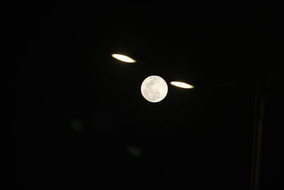 Low angle view of moon in the dark