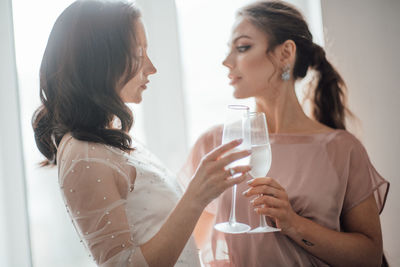 Rear view of a woman drinking glass