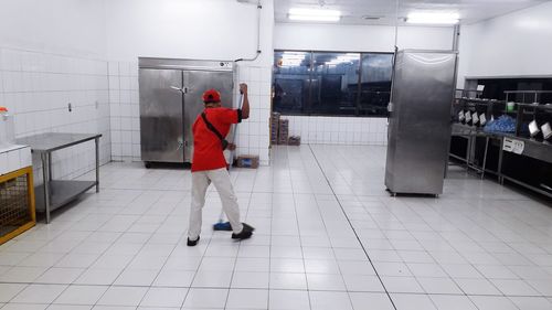 Rear view of woman walking in shopping mall