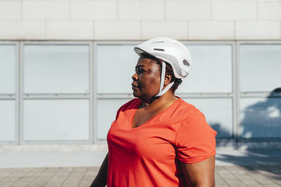 Woman wearing cycling helmet on sunny day