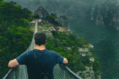 Rear view of man on footbridge