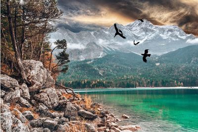 Scenic view of lake and rocks against sky