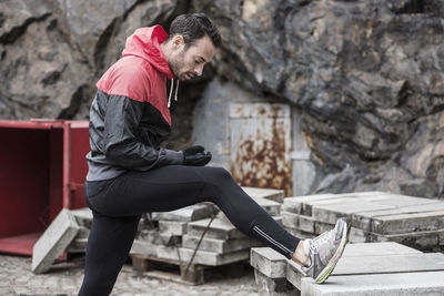 Man stretching leg on slab