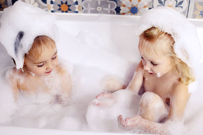 High angle view of woman washing hands in bathtub