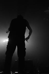 Low angle view of silhouette people at night