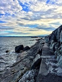 Rocks on beach against sky