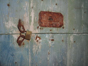 Close-up of rusty metal on wooden plank