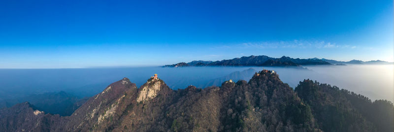 Panoramic view of mountains against blue sky