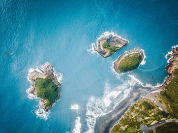 High angle view of rocks on sea shore