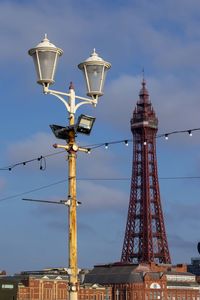 Low angle view of street light against cloudy sky