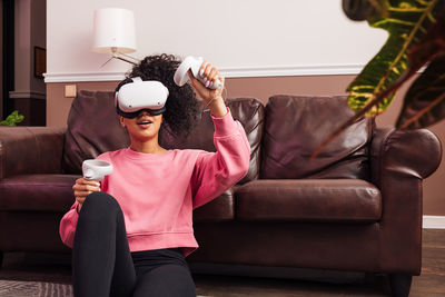 Young woman playing game wearing vr headset