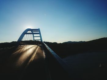 Road against clear blue sky