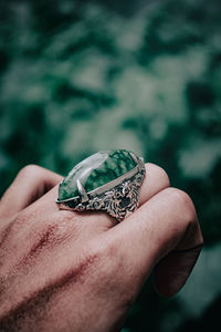 Cropped hand of person holding ring