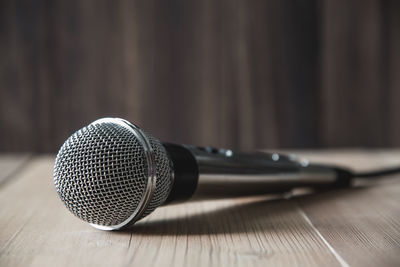 Close-up of microphone on wooden table