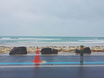 Traffic cones on road in beach