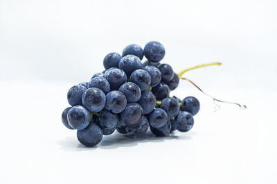 Close-up of grapes against white background