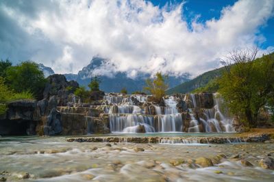 Panoramic view of waterfall against sky