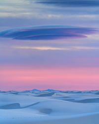 Scenic view of snowy landscape against sky during sunset