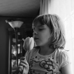 Girl holding tulip at home