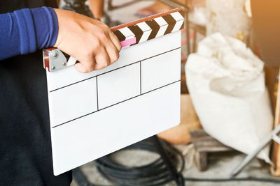 Close-up of person holding film slate