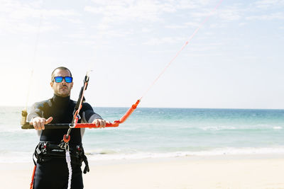 Full length portrait of man standing on beach