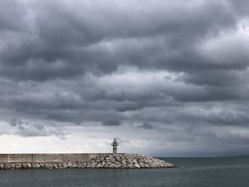 Scenic view of sea against cloudy sky