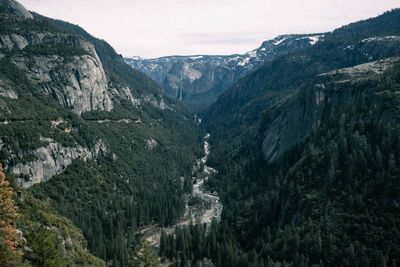 High angle view of valley and mountains against sky