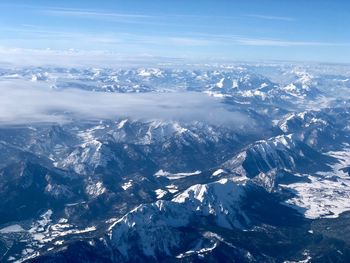 Aerial view of snowcapped mountains against sky